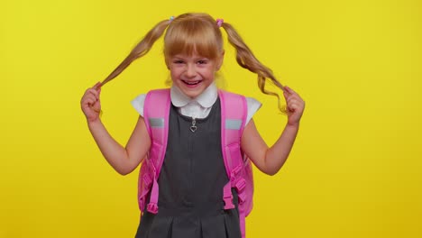 Happy-girl-kid-in-school-uniform-play-with-pony-tails-laugh-fooling-around-making-playful-silly-face