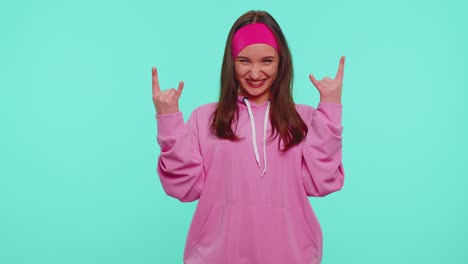 Overjoyed-teen-girl-showing-rock-n-roll-gesture-by-hands,-cool-sign,-shouting-yeah-with-crazy-face
