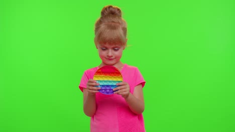 Children-girl-kid-playing-pop-it-sensory-toy,-trendy-fidgeting-anti-stress-silicone-bubbles-game