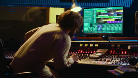 Audio-technician-uses-mixing-and-mastering-techniques-in-studio