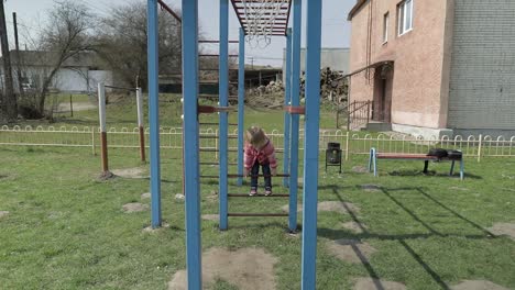 Funny-cute-girl-is-playing.-Joyous-female-child-having-fun-on-playground