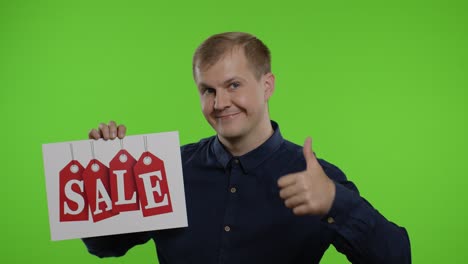 Happy-man-holding-Sale-word-inscription-and-showing-thumb-up.-Guy-rejoicing-with-good-sale-discounts