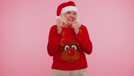 Grandmother-woman-in-sweater-Christmas-Santa-shouting,-celebrating-success,-winning,-goal-achievemen