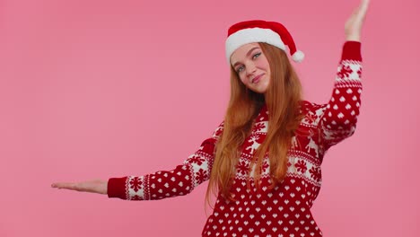Woman-wears-red-New-Year-sweater-deer-showing-thumbs-up-and-pointing-at-on-blank-advertisement-space