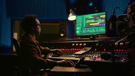 African-american-sound-designer-working-with-editing-software-to-produce-tracks