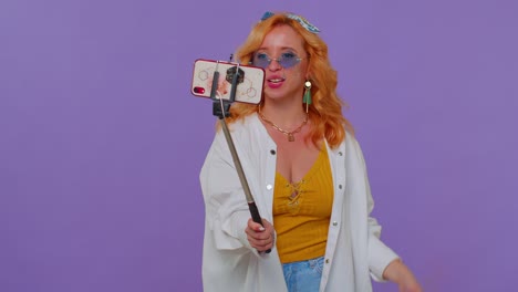 Girl-traveler-blogger-in-sunglasses,-taking-selfie-on-mobile-phone,-communicating-video-call-online