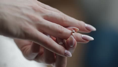 Elegant-blonde-bride-wear-beautiful-engagement-ring.-Woman-at-wedding-morning