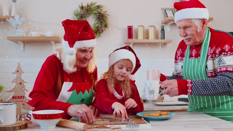 Grandfather-with-cups-hot-chocolate-walking-on-Christmas-home-kitchen-to-grandmother-and-grandchild