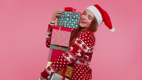 Woman-in-Christmas-red-sweater,-Santa-hat-smiling-holding-many-gift-boxes-New-Year-presents-shopping