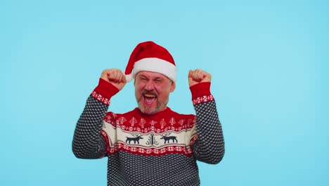 Cheerful-man-in-sweater-Christmas-Santa-shouting,-celebrating-success,-winning,-goal-achievemen