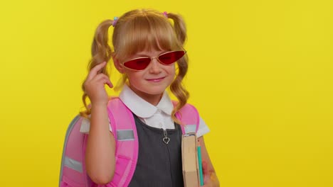 Pretty-cute-teen-girl-kid-in-school-uniform-and-sunglasses-winking-eye,-looking-at-camera-with-smile