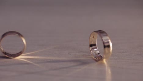 Two-wedding-rings-rolling-on-the-floor