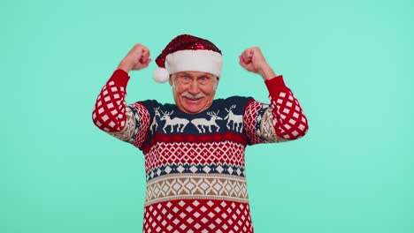 Grandfather-man-in-sweater-Christmas-Santa-shouting,-celebrating-success,-winning,-goal-achievemen