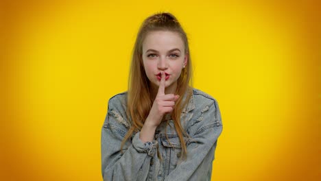 Girl-presses-index-finger-to-lips-makes-silence-gesture-sign-do-not-tells-secret,-shh-be-quiet