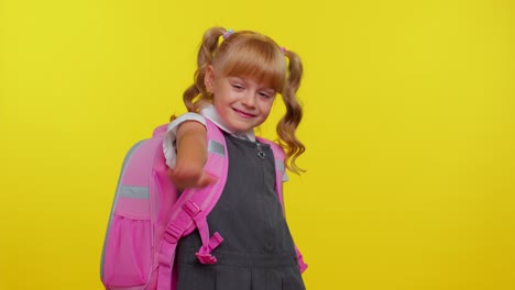 Cheerful-teenage-schoolgirl-kid-dressed-in-uniform-waves-hand-palm-in-hello-gesture-welcomes-someone