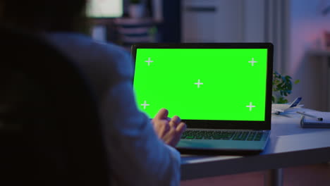 Close-up-of-freelancer-typing-on-laptop-with-green-screen-overtime