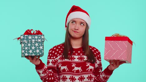 Woman-in-Christmas-red-sweater-Santa-hat,-smiling,-holding-two-gift-boxes-New-Year-presents-shopping