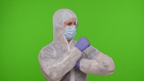 Medical-worker-doctor-in-PPE-protective-suit-dancing,-celebrating-victory-on-chroma-key-background