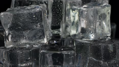 Pouring-soda,-alcohol-vodka,-tequila,-gin,-water-into-drinking-glass-with-ice-cubes,-slow-motion