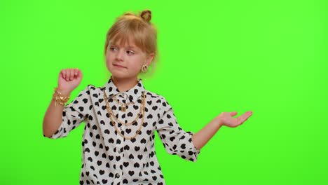 Funny-child-girl-showing-thumbs-up-and-pointing-empty-place,-advertising-area-for-commercial-text