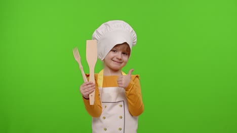 Child-girl-cook-chef-baker-in-apron-and-hat-smiling,-nods-head-in-agreement-on-chroma-key-background