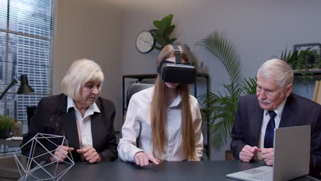 Businesswoman-using-VR-app-headset-helmet-doing-research-watching-virtual-reality-graph-at-office