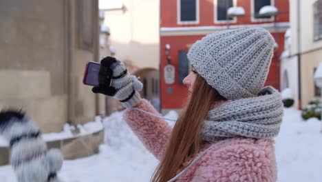 Girl-traveler-using-mobile-phone-camera-with-application-taking-photo-recording-video-on-city-street