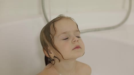 Attractive-three-years-old-girl-takes-a-bath.-Cleaning-and-washing-hair