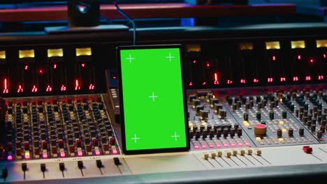 Audio-expert-processing-sounds-next-to-tablet-with-isolated-mockup