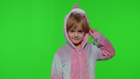 Child-girl-in-unicorn-pajamas-making-silly-funny-faces,-fooling-around,-showing-tongue-on-chroma-key