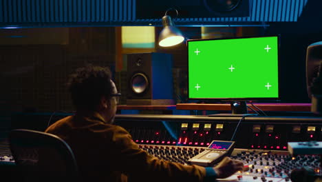 African-american-music-producer-working-with-greenscreen-on-pc