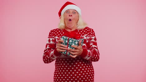 Grandmother-woman-in-sweater-Santa-Christmas-getting-present-gift-box-expressing-amazement-happiness