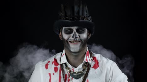 Sinister-man-with-skeleton-makeup-opening-his-mouth-and-showing-dirty-black-teeth-smile.-Halloween