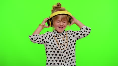 Attractive-blonde-child-kid-listening-music-via-headphones-dancing-disco-fooling-having-fun-party