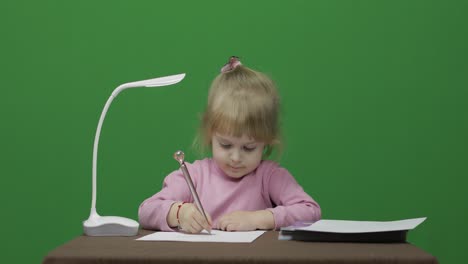Girl-drawing-at-the-table.-Education-process.-Three-years-old-child.-Chroma-Key