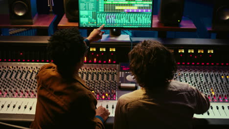 Team-of-sound-engineers-working-on-recording-and-editing-tracks