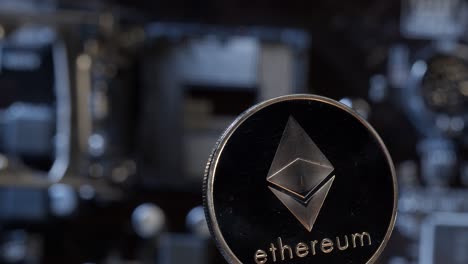 Ethereum-coin-spinning-on-computer-motherboard-background,-cryptocurrency-mining,-virtual-money