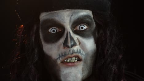 Frightening-man-in-skeleton-Halloween-makeup-screaming,-shouting,-making-faces,-trying-to-scare