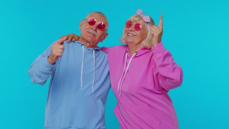 Lovely-senior-couple-man-woman-grandparents-listening-music-dancing-disco-fooling-around-having-fun
