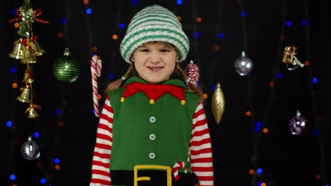Displesed-kid-teenager-girl-in-elf-Santa-helper-costume-negative-emotions,-upset-on-Christmas-Eve