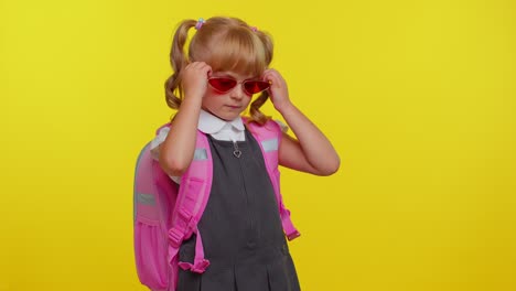 Beautiful-cute-smiling-schoolgirl-with-backpack-wearing-sunglasses,-charming-smile,-posing,-dancing