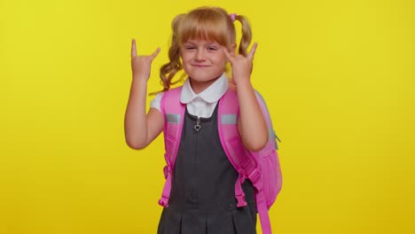 Overjoyed-funny-pupil-school-girl-showing-rock-n-roll-gesture-by-hands,-cool-sign,-crazy-expression