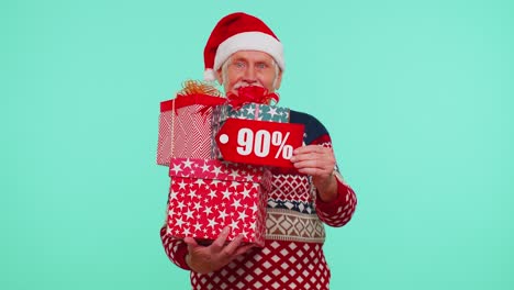 Senior-man-in-Christmas-sweater-showing-gift-box-and-90-Percent-discount-inscriptions-banner-text