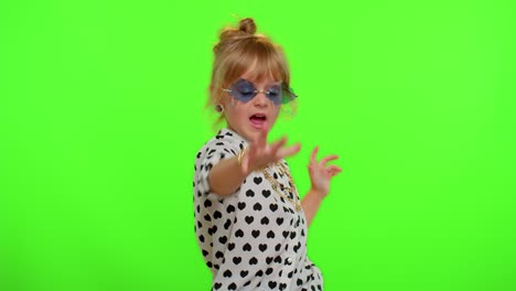 Little-teen-kid-child-girl-in-stylish-sunglasses-listening-music,-dancing-disco,-fooling,-having-fun