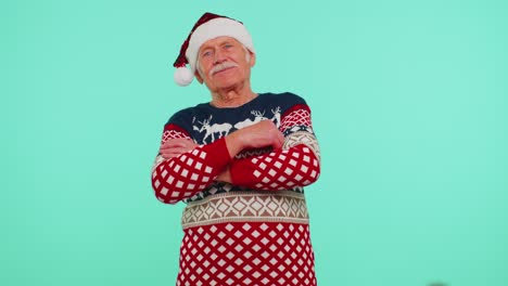 Elderly-senior-lovely-grandfather-man-wears-red-New-Year-sweater-and-hat-smiling,-looking-at-camera