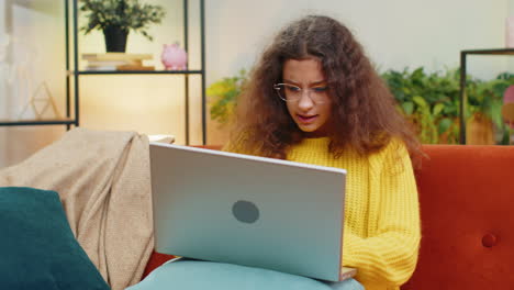 Amazed-teen-girl-use-laptop-computer,-receive-good-news-message,-shocked-by-victory,-celebrate-win