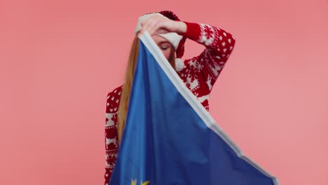 Girl-in-Christmas-sweater-waving-European-Union-flag,-smiling,-cheering-democratic-laws-human-rights