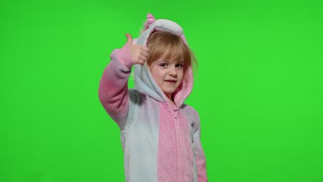 Little-child-girl-smiling,-showing-thumbs-up-gesture,-agree-sign-in-unicorn-pajamas-on-chroma-key