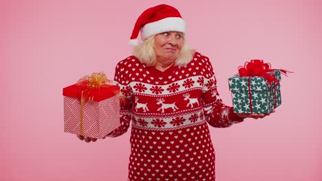 Senior-grandmother-woman-in-Christmas-sweater-holds-two-gift-boxes-in-hands,-shopping-holidays-sale