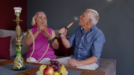 Älteres-Ehepaar-Raucht-Zu-Hause-Wasserpfeife.-Ältere-Großmutter-Und-Großvater-Haben-Spaß-Und-Entspannen-Sich